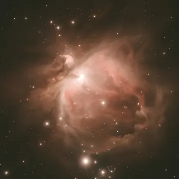 A vast, luminous nebula of gas and dust glows with many scattered stars.
