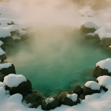 A steaming turquoise hot spring is surrounded by snow-covered rocks and ground.